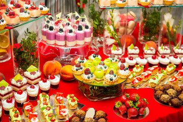 Delicious sweets on candy buffet. Lot of colorful desserts