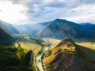 Sunset in the mountains. Valley of the Chuya River. Mountain river. Aerial landscape. Altai...