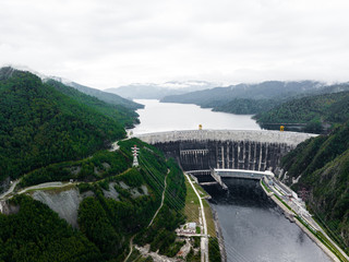 Fototapeta premium Hydroelectric power station on the Yenisei River in Siberia. Sayano-Shushenskaya Dam from aerial view