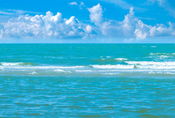 Wide view of the vast sea with ripples and colorful is beautiful. The horizon dense clouds.
