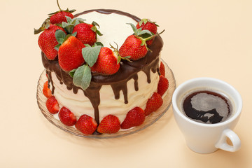 Homemade chocolate cake decorated with fresh strawberries on glass plate