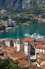 Montenegro. Top view on the picturesque Old Town of Kotor with red tiled roofs (UNESCO World Heritage site) and the two belfries of St. Tryphon's Cathedral (1166)