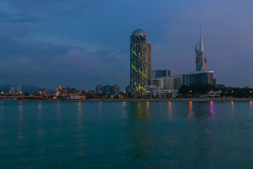 Naklejka premium Batumi, Adjara, Georgia. View from the sea on illuminated resort town at evening