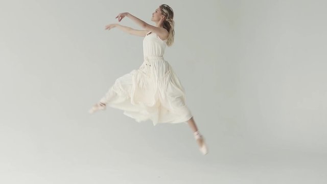 young ballet dancer in pointe shoes. The ballerina makes high beautiful jumps. concept of youth and beauty. slow motion