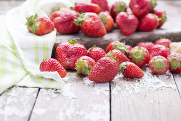 Red ripe big strawberry group on a white old vintage background