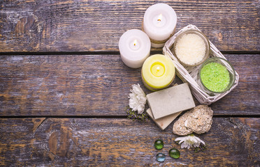 Spa treatment set on a wooden background - perfumed salt scented candles, natural soap .