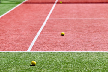 Several tennis balls on the tennis court.