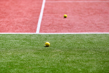 Two tennis balls on the tennis court.