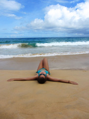 Young Woman Relaxing and Sunbathing At Beach