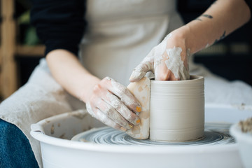 Obraz na płótnie Canvas Handcrafted on a potter's wheel,Hands make clay from various items for home and sale in the store and at the exhibition, ceramic items are made in hand, the clay billet becomes a ceramic dish
