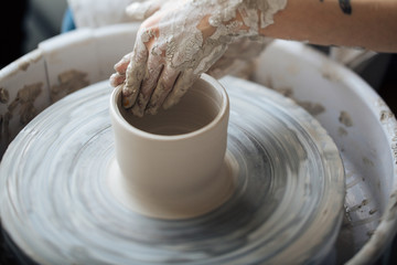 Handcrafted on a potter's wheel,Hands make clay from various items for home and sale in the store and at the exhibition, ceramic items are made in hand, the clay billet becomes a ceramic dish
