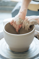 Handcrafted on a potter's wheel,Hands make clay from various items for home and sale in the store and at the exhibition, ceramic items are made in hand, the clay billet becomes a ceramic dish