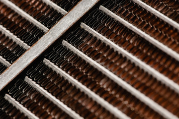 Old, rusty automotive cooler. Rusty, red lattice texture. Grid.