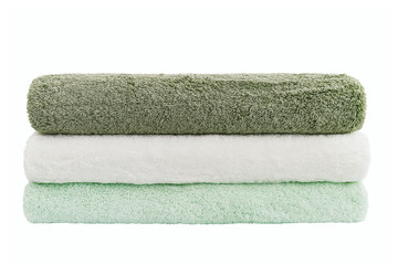 Stack of green and white towels isolated over white