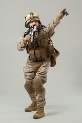 Soldier in camouflage holding rifle