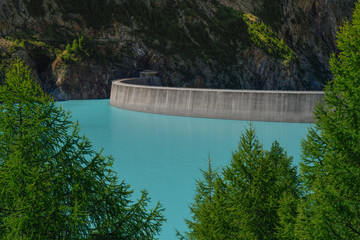 View from the dam of Place Moulin Lake, Valle d’Aosta, Italy. Alpine pond on Italian alps. Beautiful mountain panorama. Landscape of turquoise water from Bionaz pond, IT. 