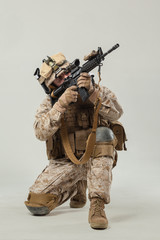 Soldier in camouflage holding rifle