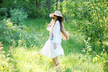 Girl in a forest glade on a sunny day