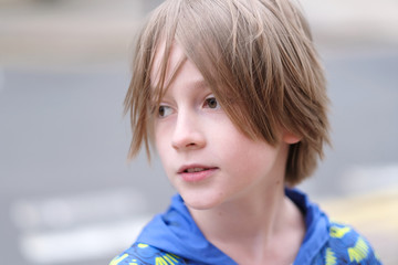 Portrait of a child with a stylish haircut in the open air