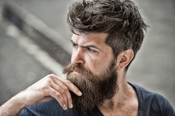 Man with beard and mustache looks thoughtful or troubled Bearded man on concentrated face touches...