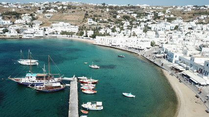 Aerial drone, bird's eye view photo of iconic and traditional whitewashed old port of Mykonos island, Cyclades, Greece