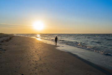 Man Walking on Beach