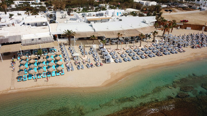 Aerial drone, bird's eye view photo of iconic and famous beach of Super Paradise with sapphire clear waters, Mykonos island, Cyclades, Greece