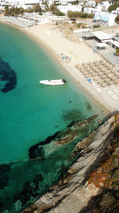 Aerial drone photo of famous turquoise clear water beach of Psarou in iconic island of Mykonos, Cyclades, Greece