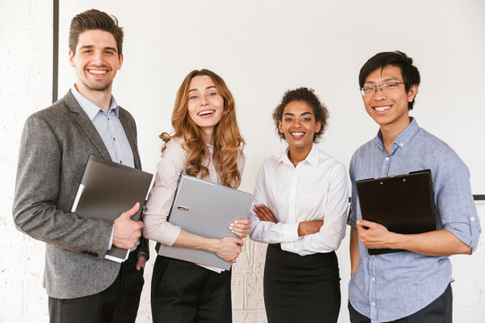 Group of cheerful young multiethnic businesspeople