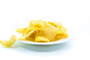 Crispy potato chips in a white plate