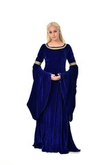 Naklejka premium full length portrait of pretty blonde lady wearing a blue fantasy medieval gown. standing pose on white background.