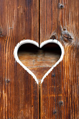 Wooden fence with heart. Part of a window in Tirol, Austria