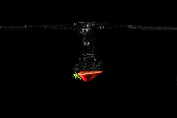 Strawberry in water black background