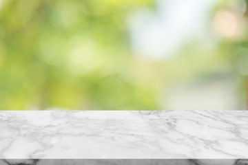 White marble stone table top on blur green background from nature, can be used for display or...