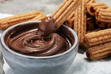 Traditional Spanish dessert churros with sugar and chocolate