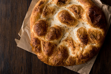 Turkish Ramadan Bread - Ramazan Pidesi on wooden surface / Pide