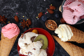 Vanilla frozen yogurt or soft ice cream in waffle cone in various flavour
