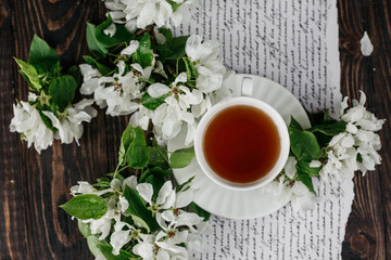 Cup of tea, book, flowers 