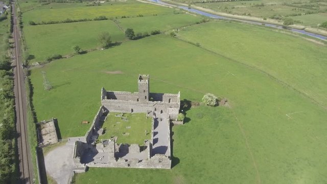 Beautiful scenic old ruins of Clare Abbey in County Clare, Ireland. Irish rural countryside with old Irish religious Abbey in decay.