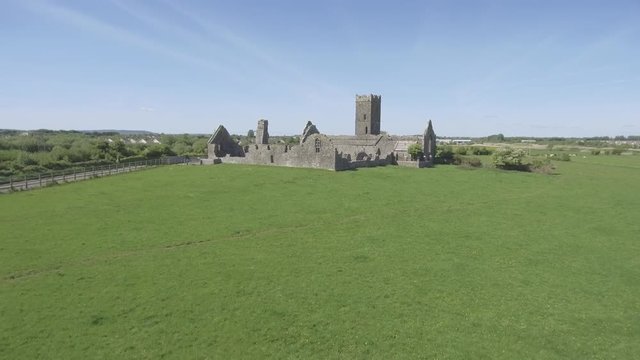 Beautiful scenic old ruins of Clare Abbey in County Clare, Ireland. Irish rural countryside with old Irish religious Abbey in decay.