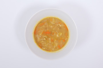 Soup with pasta and vegetables on a white