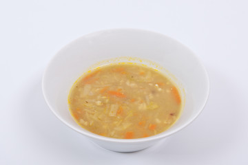 Soup with pasta and vegetables on a white