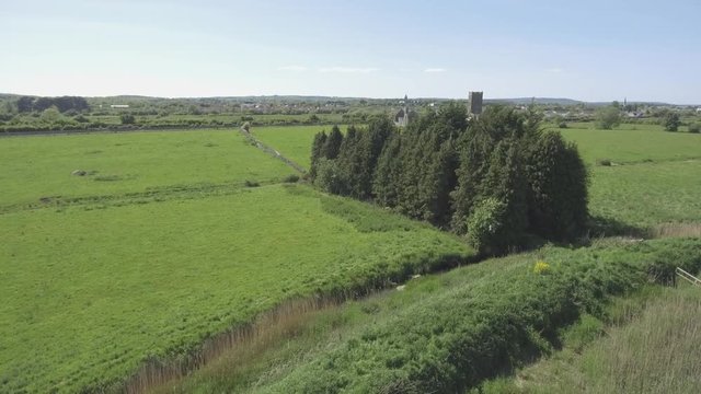 Beautiful scenic old ruins of Clare Abbey in County Clare, Ireland. Irish rural countryside with old Irish religious Abbey in decay.