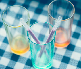 colorful glasses with sweet sticks inside