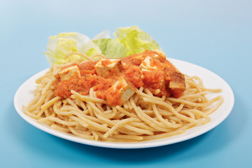 Bolognese spaghetti with tofu on a blue