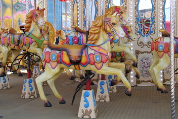 Brightly Decorated Horses on a Carousel Fun Fair Ride.