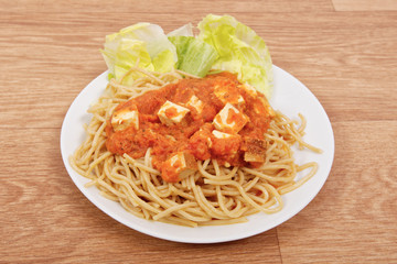 Bolognese spaghetti with tofu on a table