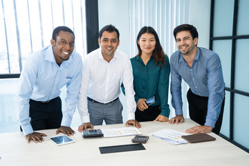 Optimistic successful managers working with audit papers