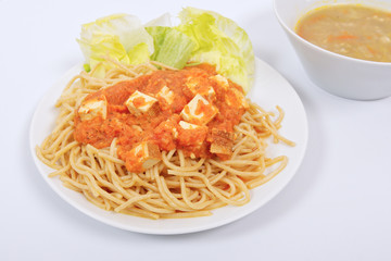 Bolognese spaghetti with tofu on a white