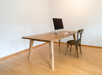 minimalist office with table and chair and computer